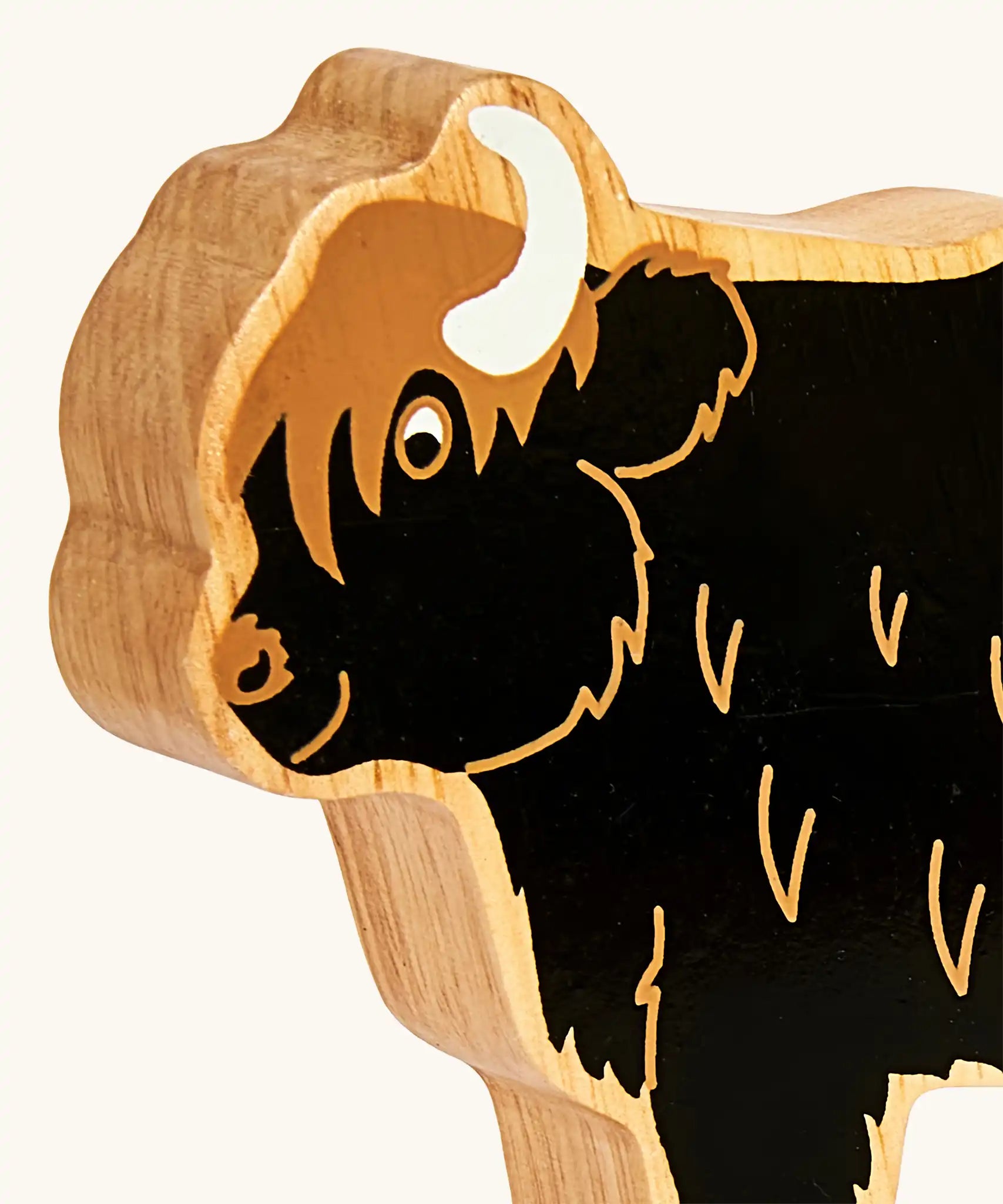 Close up of the painted facial features on the Lanka Kade black highland cow wooden toy figure. 