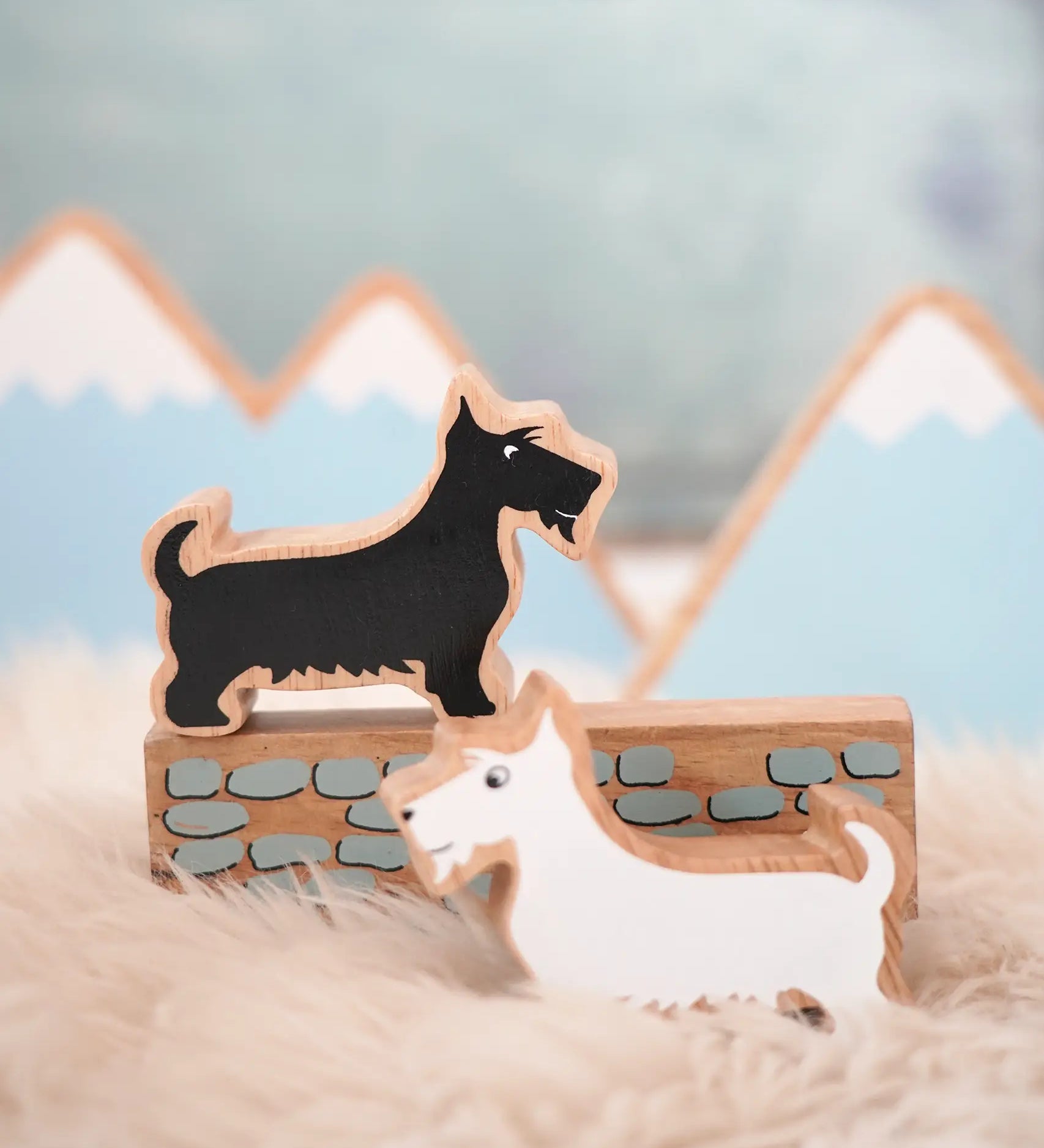 Lanka Kade scottie dog figure standing on a wooden wall piece and a white scottie dog figure