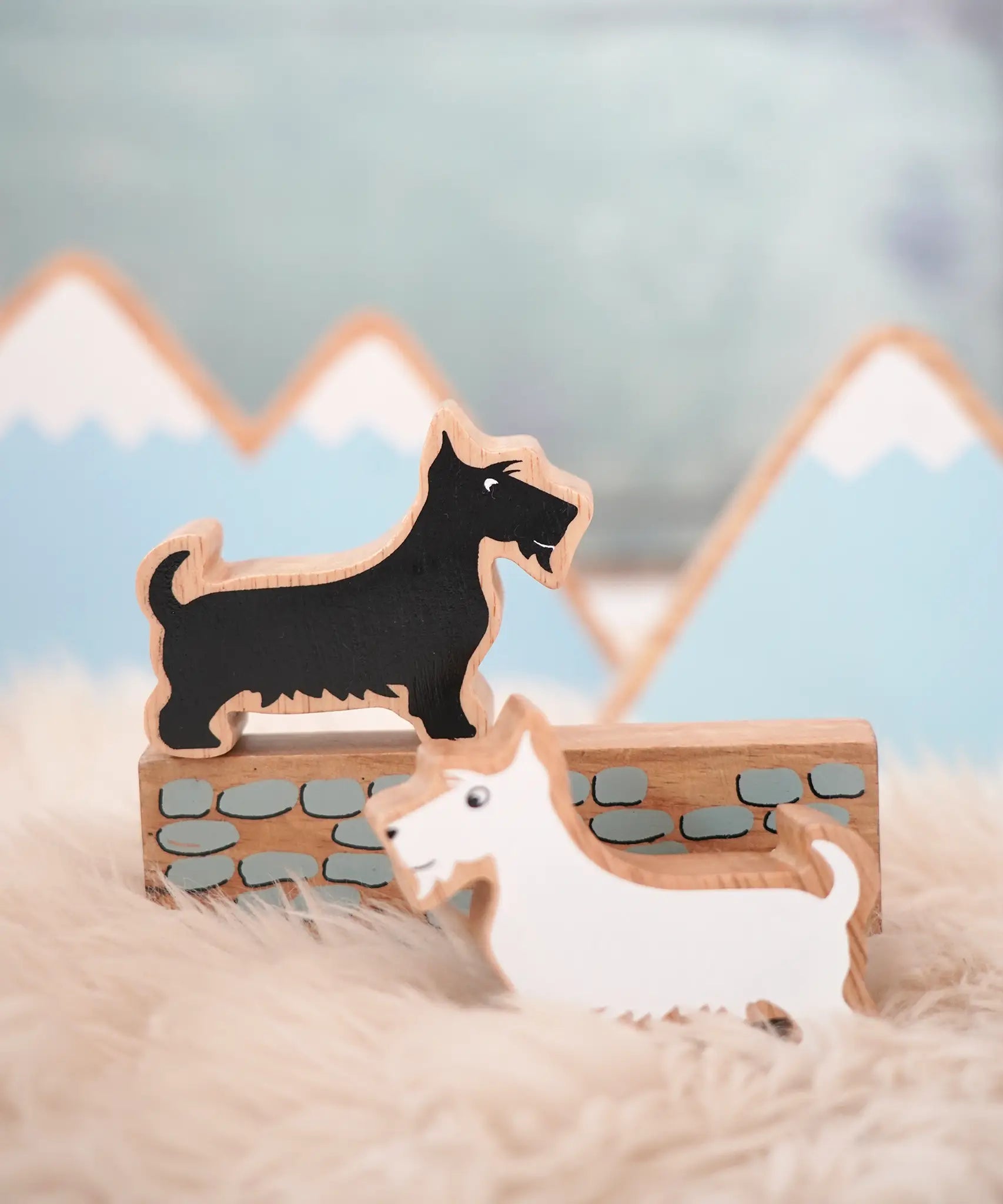 Lanka Kade scottie dog figure standing on a wooden wall piece and a white scottie dog figure