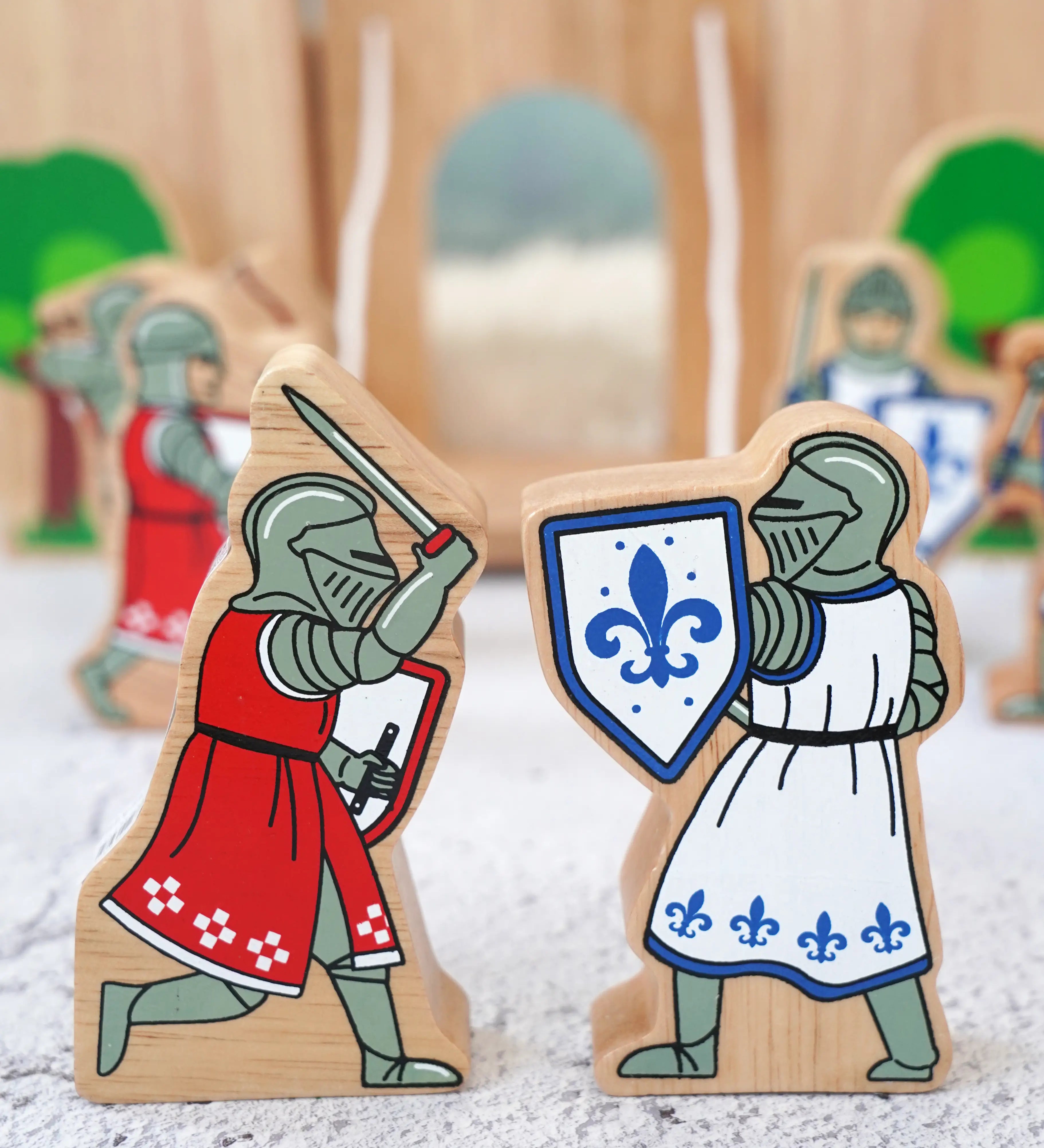 Lanka Kade blue foot knight with sword  next to red knight with sword figure with a wooden castle in the background