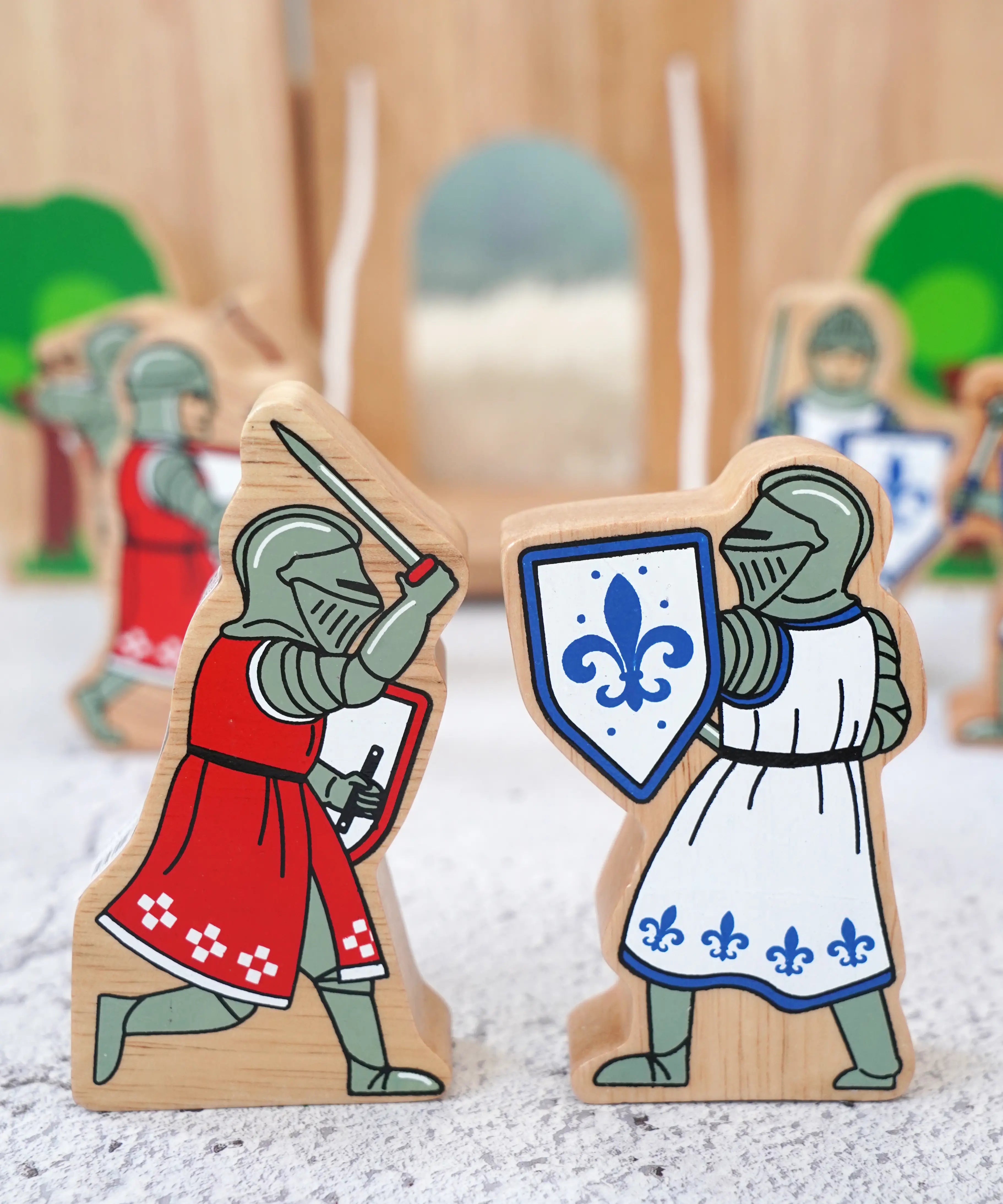 Lanka Kade blue foot knight with sword  next to red knight with sword figure with a wooden castle in the background