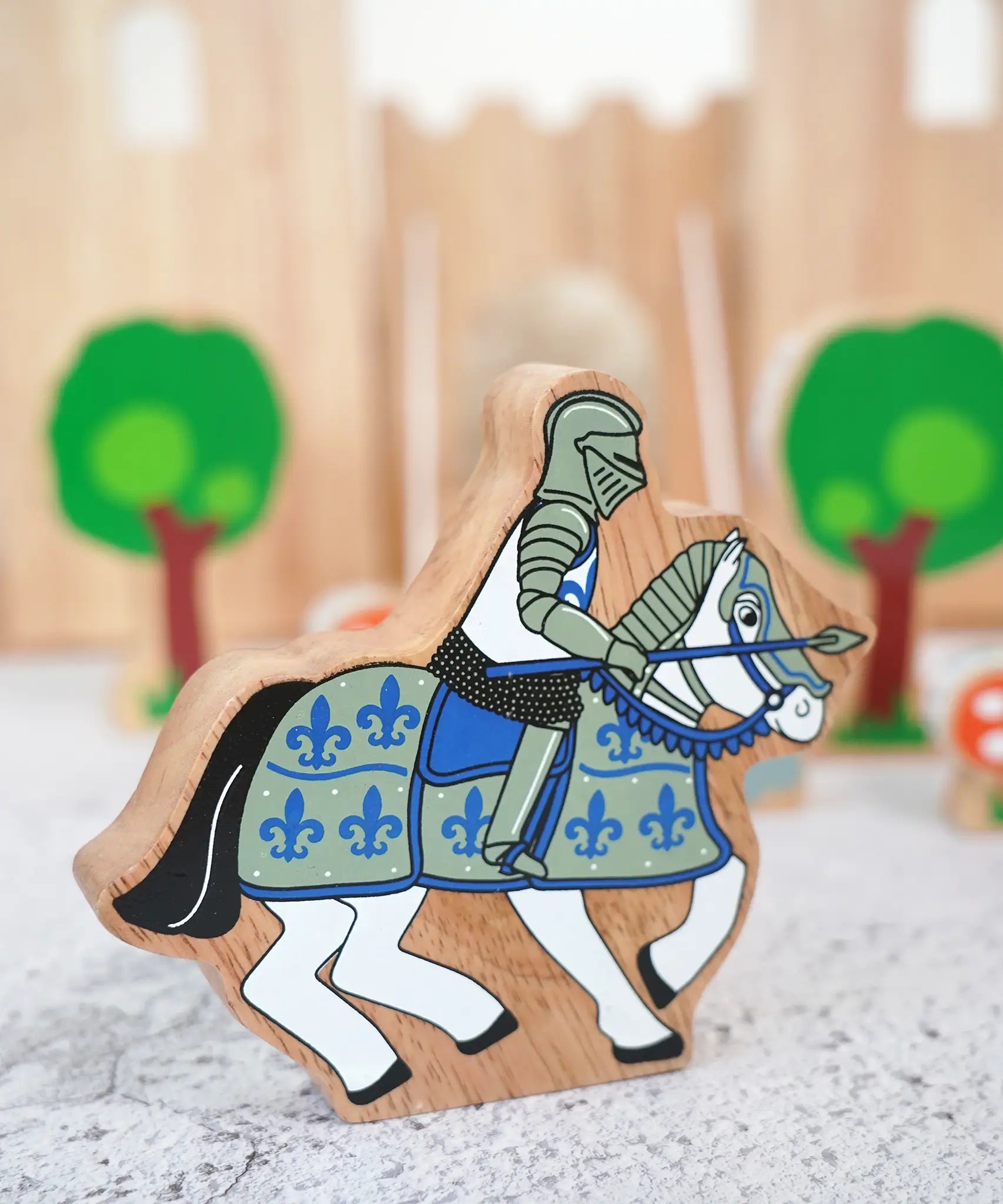 Lanka Kade wooden blue knight on horseback figure with a castle and tree figures in the background
