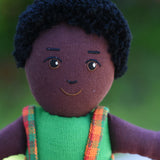 A close up of the face on the Lanka Kade Boy Doll with Black Skin and Black Hair.