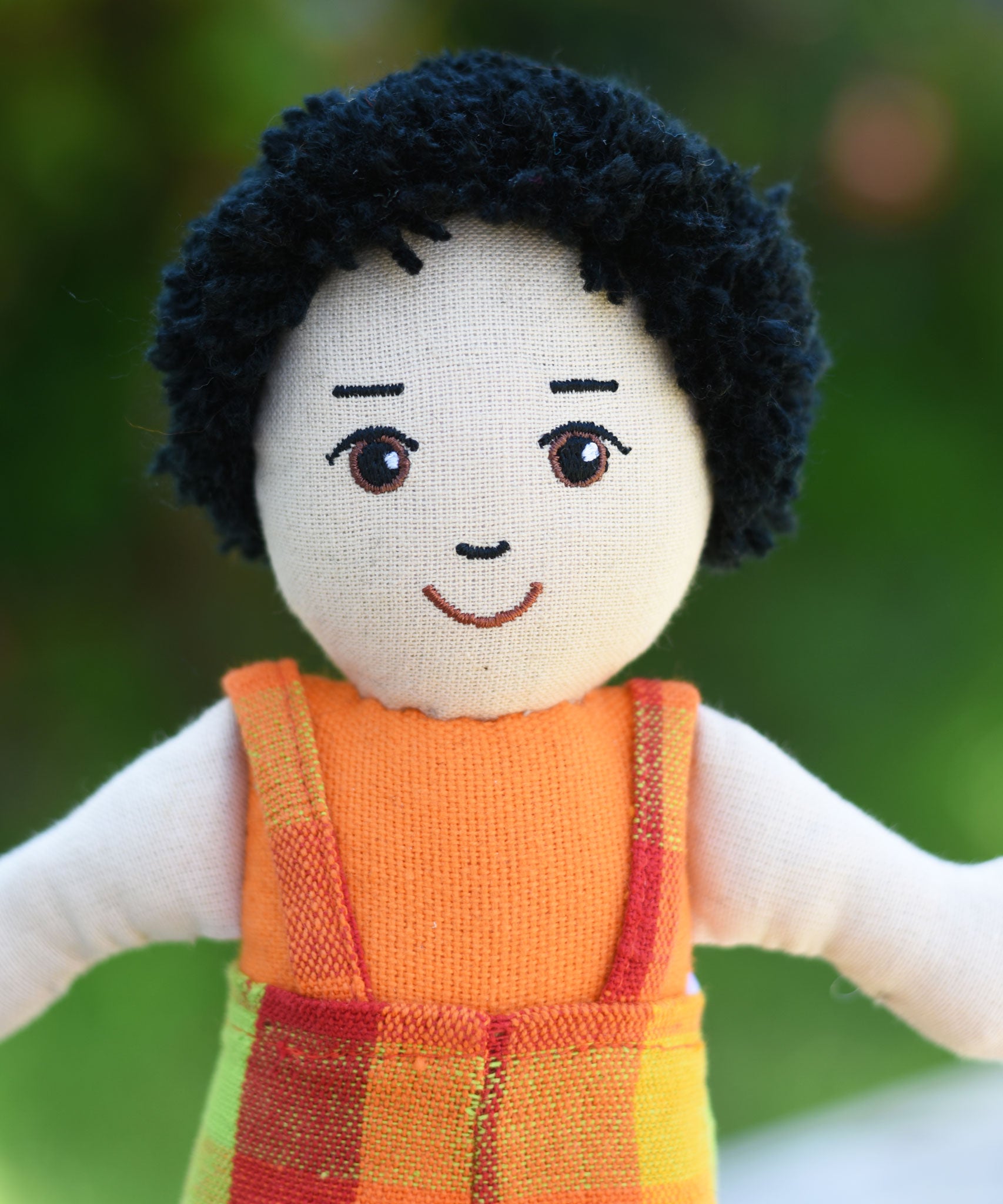A close up of the face on the Lanka Kade Boy Doll with White Skin and Black Hair.