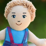 A close up of the face on the Lanka Kade Boy Doll with White Skin and Blonde Hair.