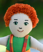 A close up of the face of a Lanka Kade Boy Doll with White Skin and Red Hair.