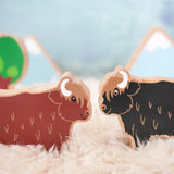 Lanka Kade brown and black highland cow figures standing face to face