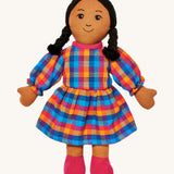 Lanka Kade mum doll with brown skin and long black hair. Features a long dress in a multicoloured check style and stitched on shoes. 