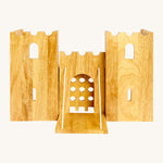 Front view of the wooden Lanka Kade castle showing the corner walls with window holes, the lowered drawbridge and gate. 
