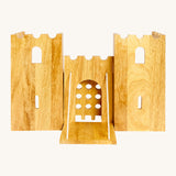 Front view of the wooden Lanka Kade castle showing the corner walls with window holes, the lowered drawbridge and gate. 
