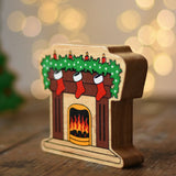 Lanka Kade festive fireplace wooden Christmas wooden toy figure. Brown fireplace with a lit fire, three red stocking hanging with a garland on the mantel decorated with 4 candles. 