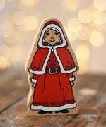 Lanka Kade Mrs Claus Christmas  wooden toy figure placed on a wooden surface in the Babipur playroom.