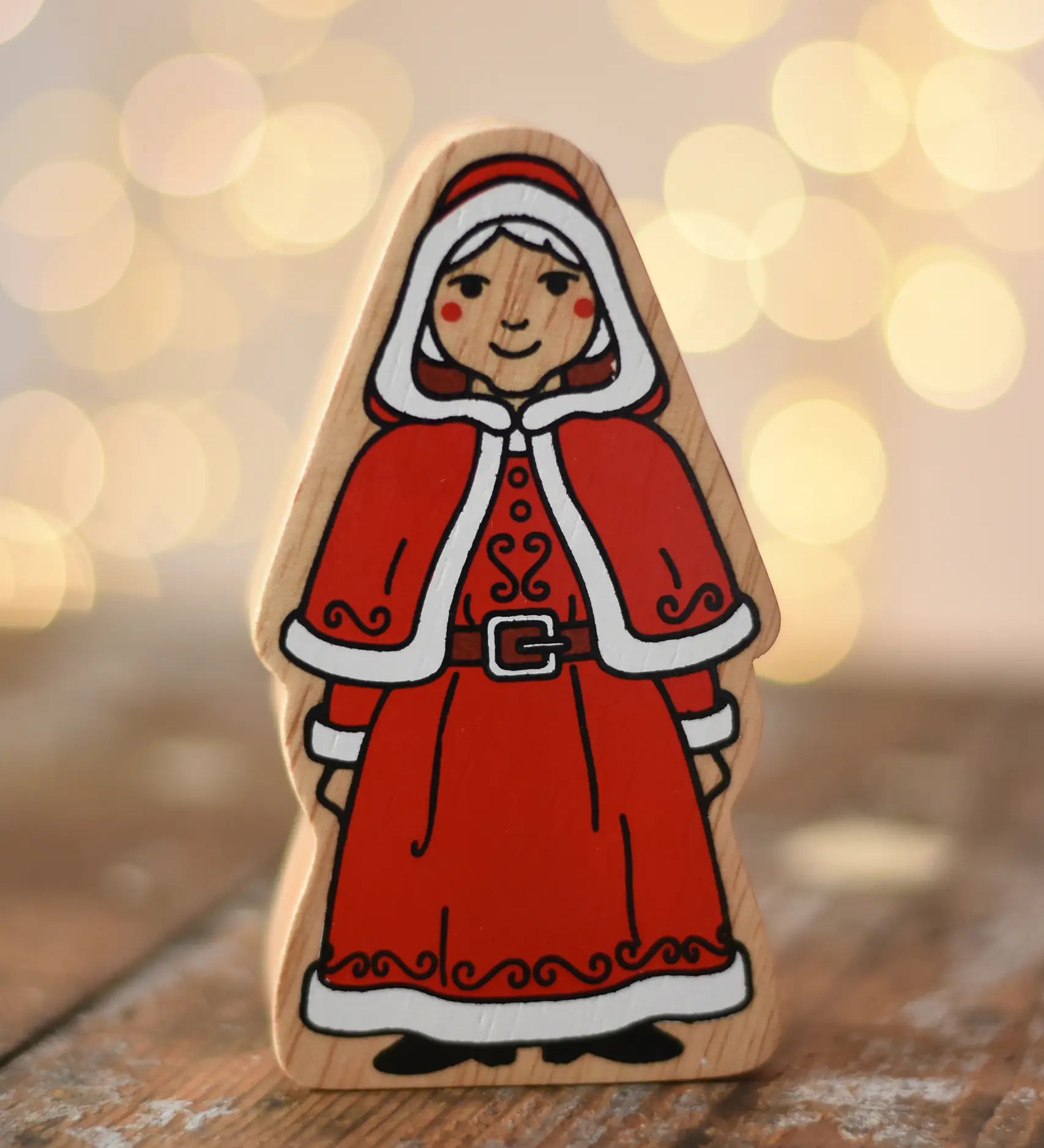 Lanka Kade Mrs Claus Christmas  wooden toy figure placed on a wooden surface in the Babipur playroom.