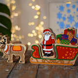Lanka Kade wooden Christmas toy figures including Father Christmas, red sleigh, wrapped presents,and 2 Reindeer placed on a wooden surface in the Babipur playroom.