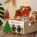 Lanka Kade wooden Christmas play set. 9 toy figures including Santa in his sleigh, Mrs Clause, Christmas Tree, Snowman, North Pole Sign, 2 Elves and 2 Reindeer placed in a wooden crate with the Welsh words bocs nadolig on the front.