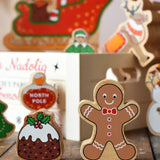Lanka Kade gingerbread man and Christmas pudding wooden toy figure placed on a wooden surface in the Babipur playroom.