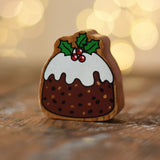 Lanka Kade Christmas pudding wooden toy figure placed on a wooden surface in the Babipur playroom.