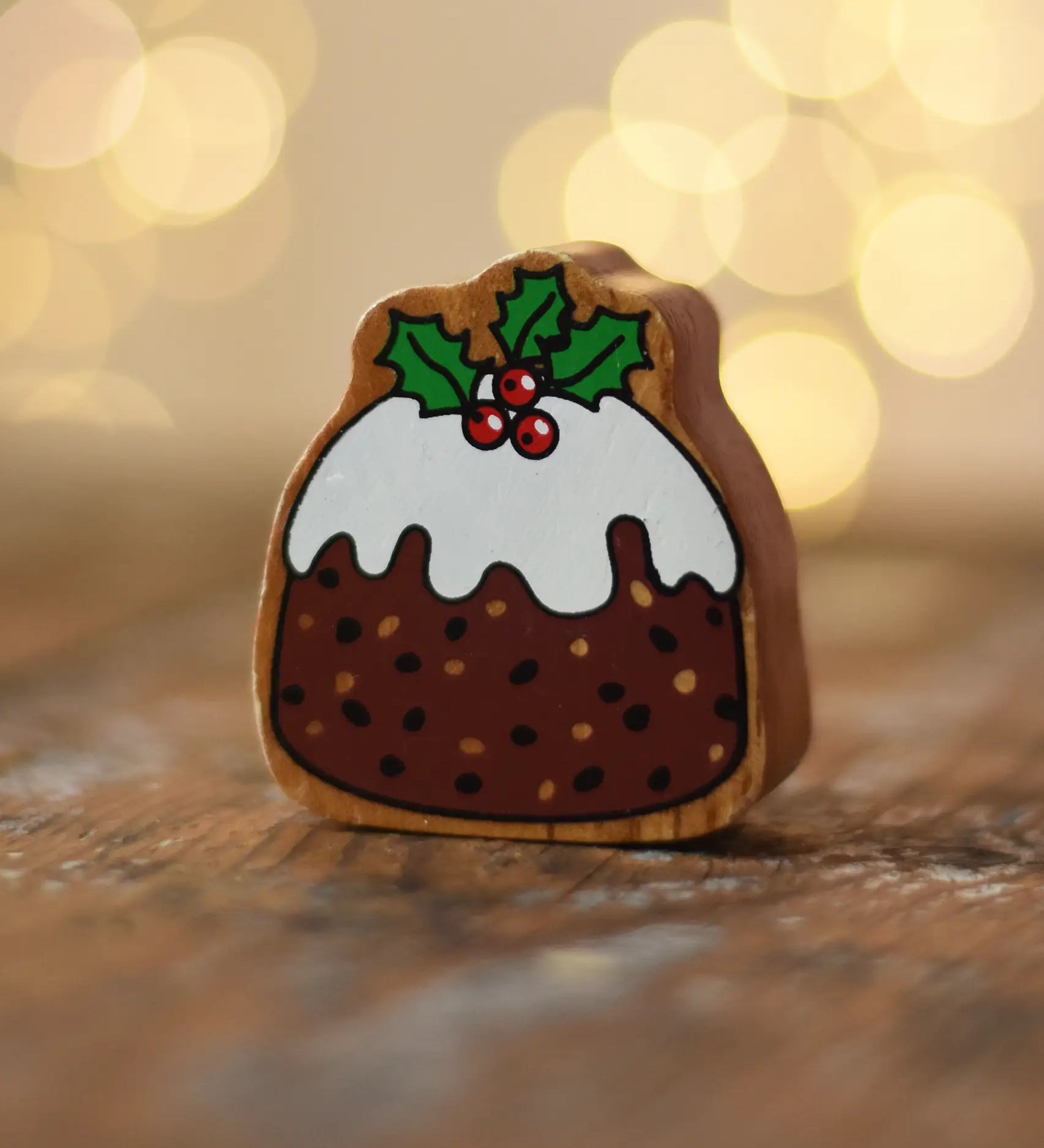 Lanka Kade Christmas pudding wooden toy figure placed on a wooden surface in the Babipur playroom.