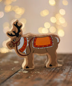 Lanka Kade Christmas reindeer wooden toy figure placed on a wooden surface in the Babipur playroom.