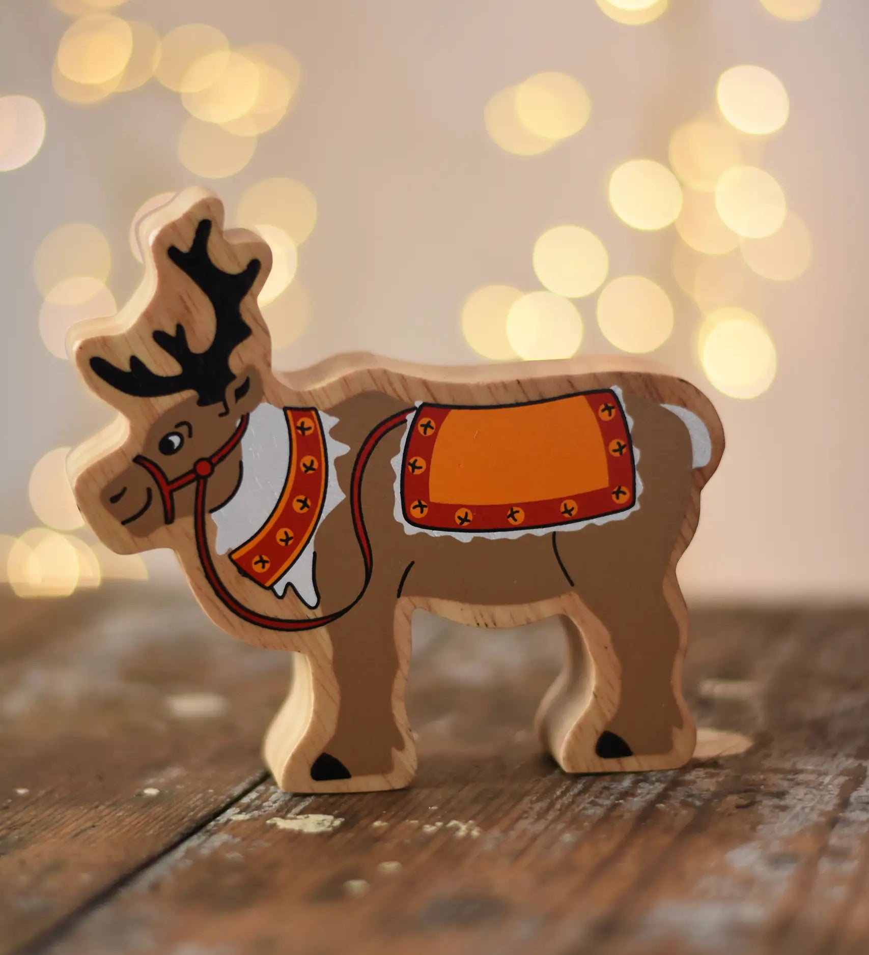 Lanka Kade Christmas reindeer wooden toy figure placed on a wooden surface in the Babipur playroom.
