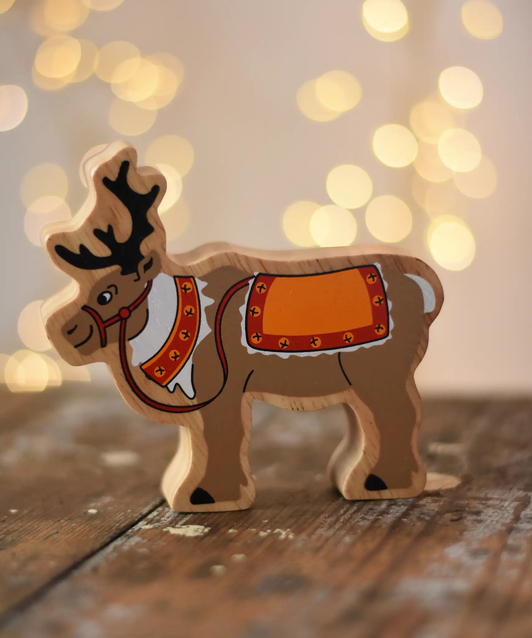 Lanka Kade Christmas reindeer wooden toy figure placed on a wooden surface in the Babipur playroom.