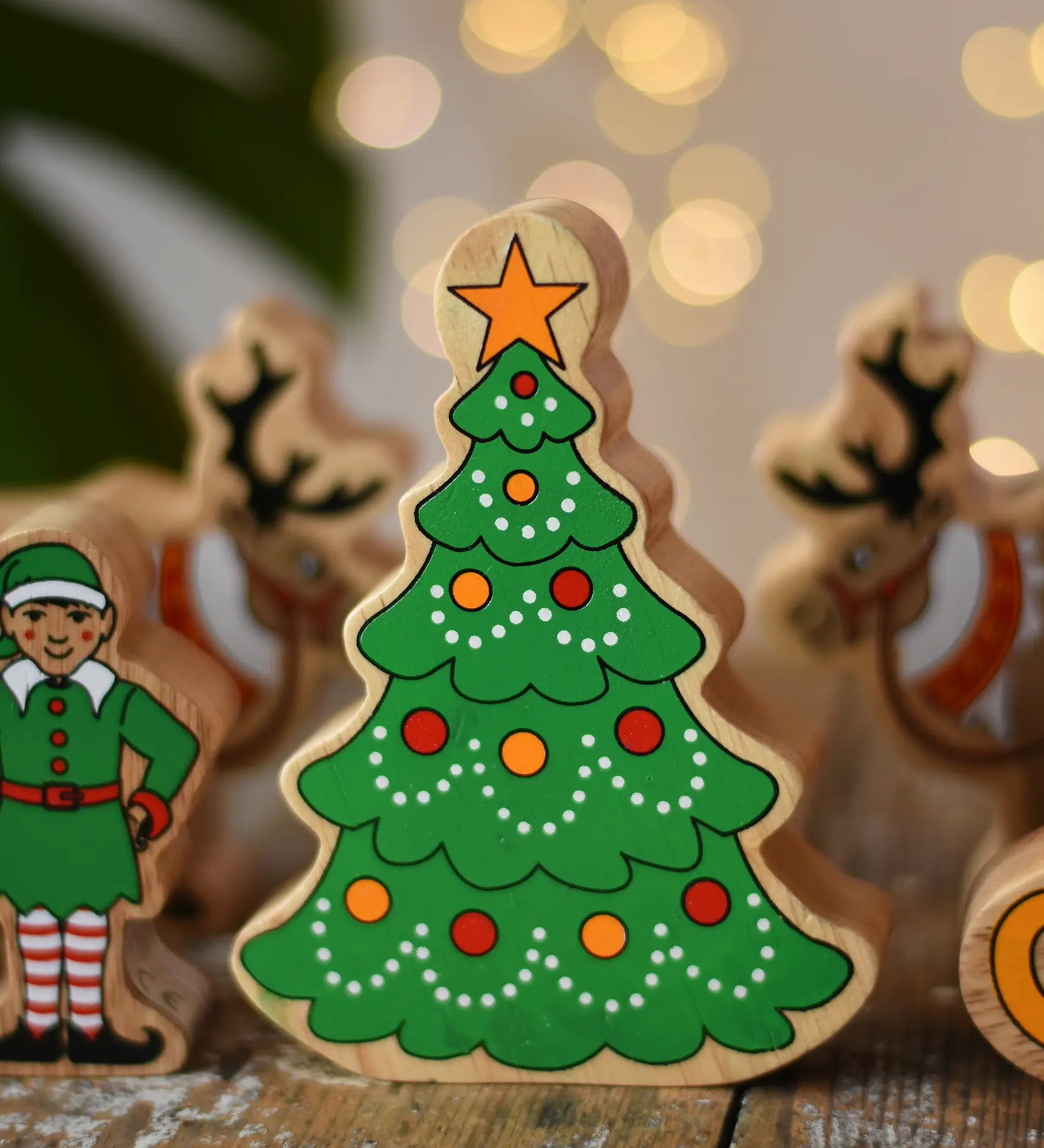Lanka Kade Christmas tree wooden toy figure painted with red and yellow baubles and a yellow star on the top.