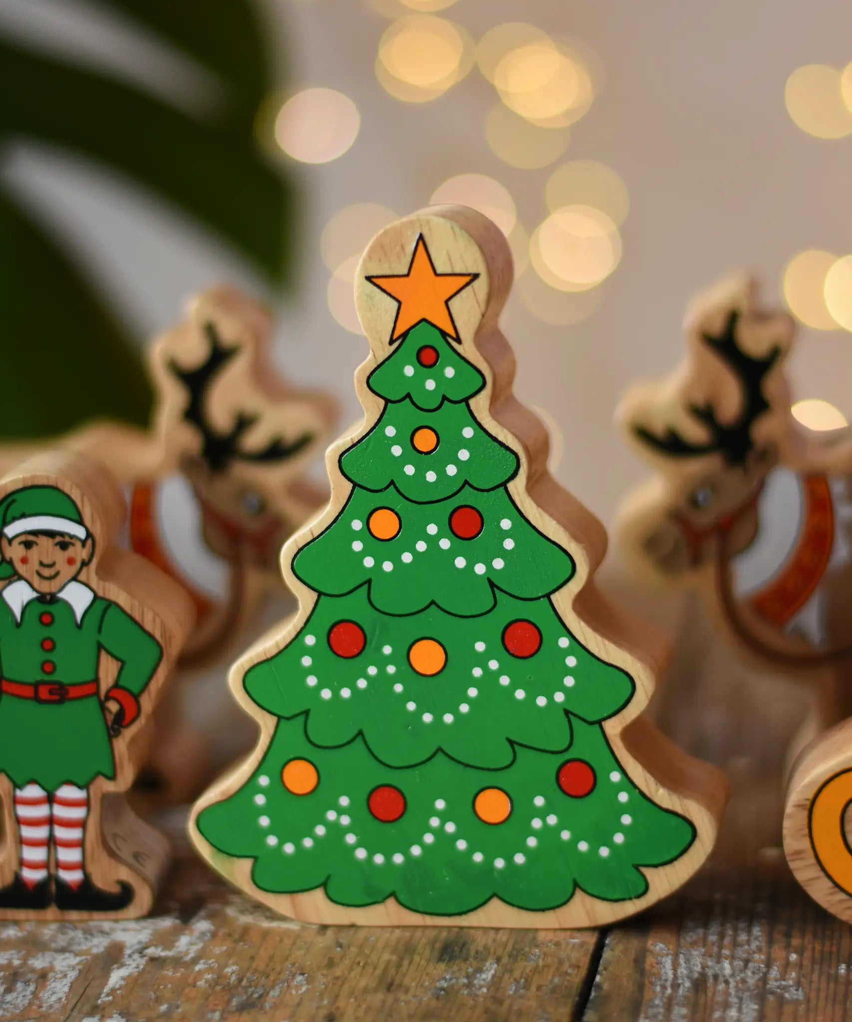 Lanka Kade Christmas tree wooden toy figure painted with red and yellow baubles and a yellow star on the top.