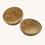 A close up of the coconut bowls from the coconut water play set showing the 2 shells with holes in the bottom for water to pour through them