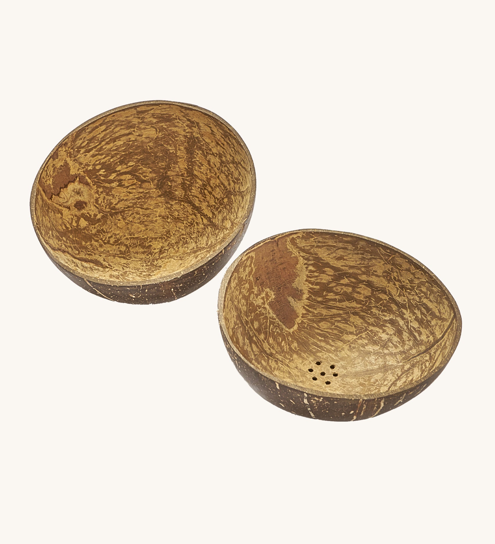 A close up of the coconut bowls from the coconut water play set showing the 2 shells with holes in the bottom for water to pour through them