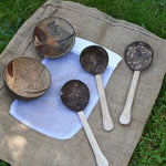 The 5 items included in the Lanka Kade coconut shell water playset placed the white mesh storage bag that they come inside. 