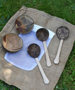 The 5 items included in the Lanka Kade coconut shell water playset placed the white mesh storage bag that they come inside. 