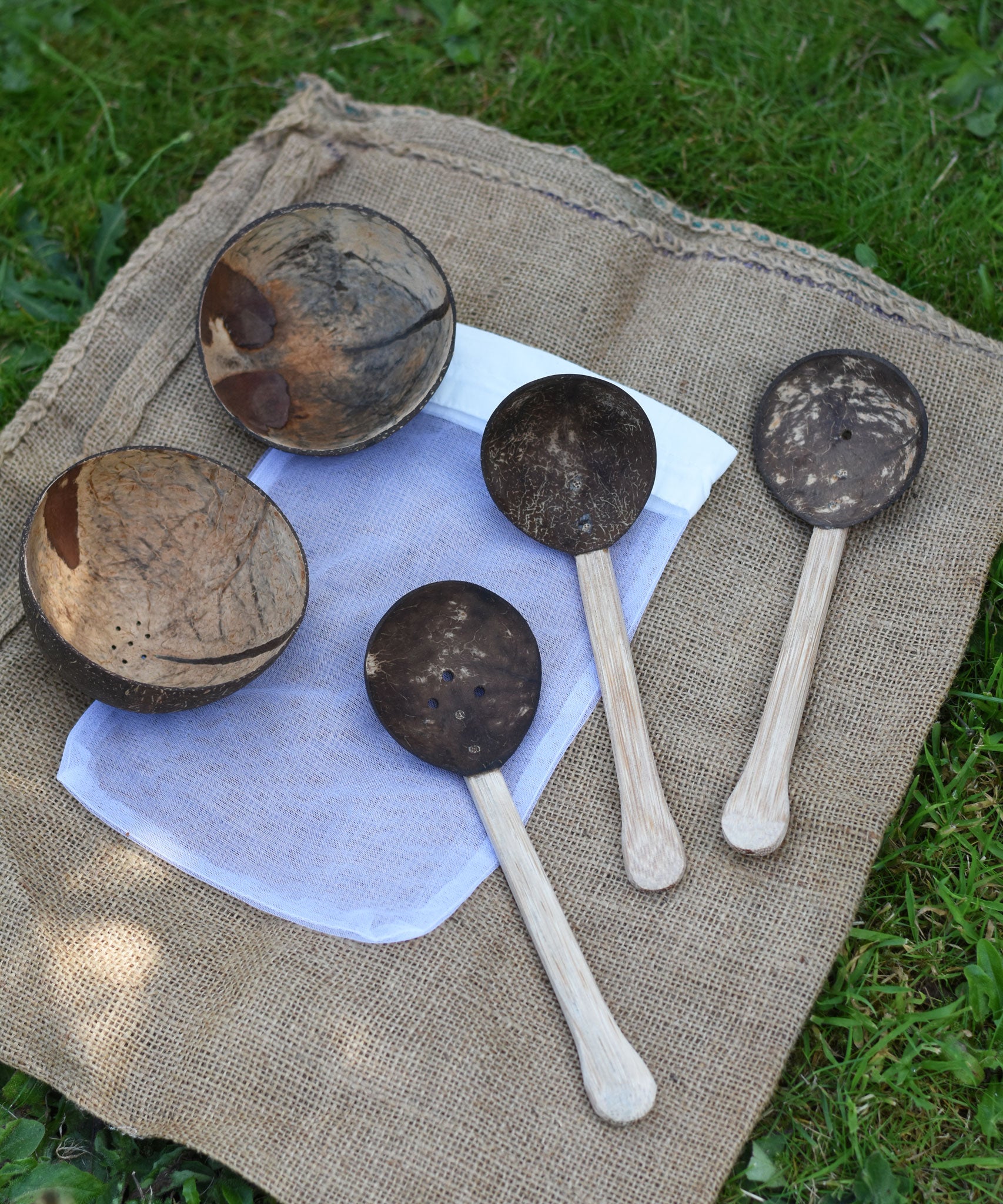 The 5 items included in the Lanka Kade coconut shell water playset placed the white mesh storage bag that they come inside. 