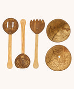 All the pieces from the Lanka Kade Coconut Shell Sand Playset pictured next to each other. Three utensils and two bowls are included in the set. 