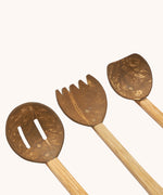 A close up of the three utensils included in the Lanka Kade Coconut Shell Sand Playset.