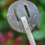 A close up of the back of a slotted spoon from the range of coconut shell utensils from  Lanka Kade. 