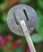 A close up of the back of a slotted spoon from the range of coconut shell utensils from  Lanka Kade. 