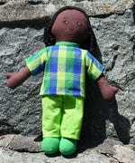 A Lanka Kade Rag Doll Dad - Black Skin, Black Hair placed on a stone wall outdoors. 