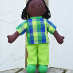 A Lanka Kade Rag Doll Dad - Black Skin, Black Hair placed on wooden decking outdoors.