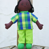 A Lanka Kade Rag Doll Dad - Black Skin, Black Hair placed on wooden decking outdoors.