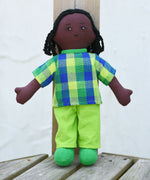 A Lanka Kade Rag Doll Dad - Black Skin, Black Hair placed on wooden decking outdoors.