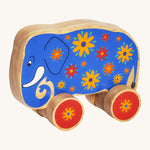 A blue wooden Lanka Kade push along elephant with yellow and red flowers with red wheels on a cream background.