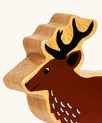 Close up of the painted facial features on the Lanka Kade dark brown stag wooden toy figure.