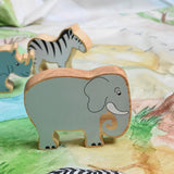A Lanka Kade grey elephant wooden toy figure placed on a Wonderie plains of Africa play cloth. These wooden toy figures are part of a huge range of Lanka Kade fair trade, wooden toys available here at Babipur.