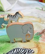 A Lanka Kade grey elephant wooden toy figure placed on a Wonderie plains of Africa play cloth. These wooden toy figures are part of a huge range of Lanka Kade fair trade, wooden toys available here at Babipur.
