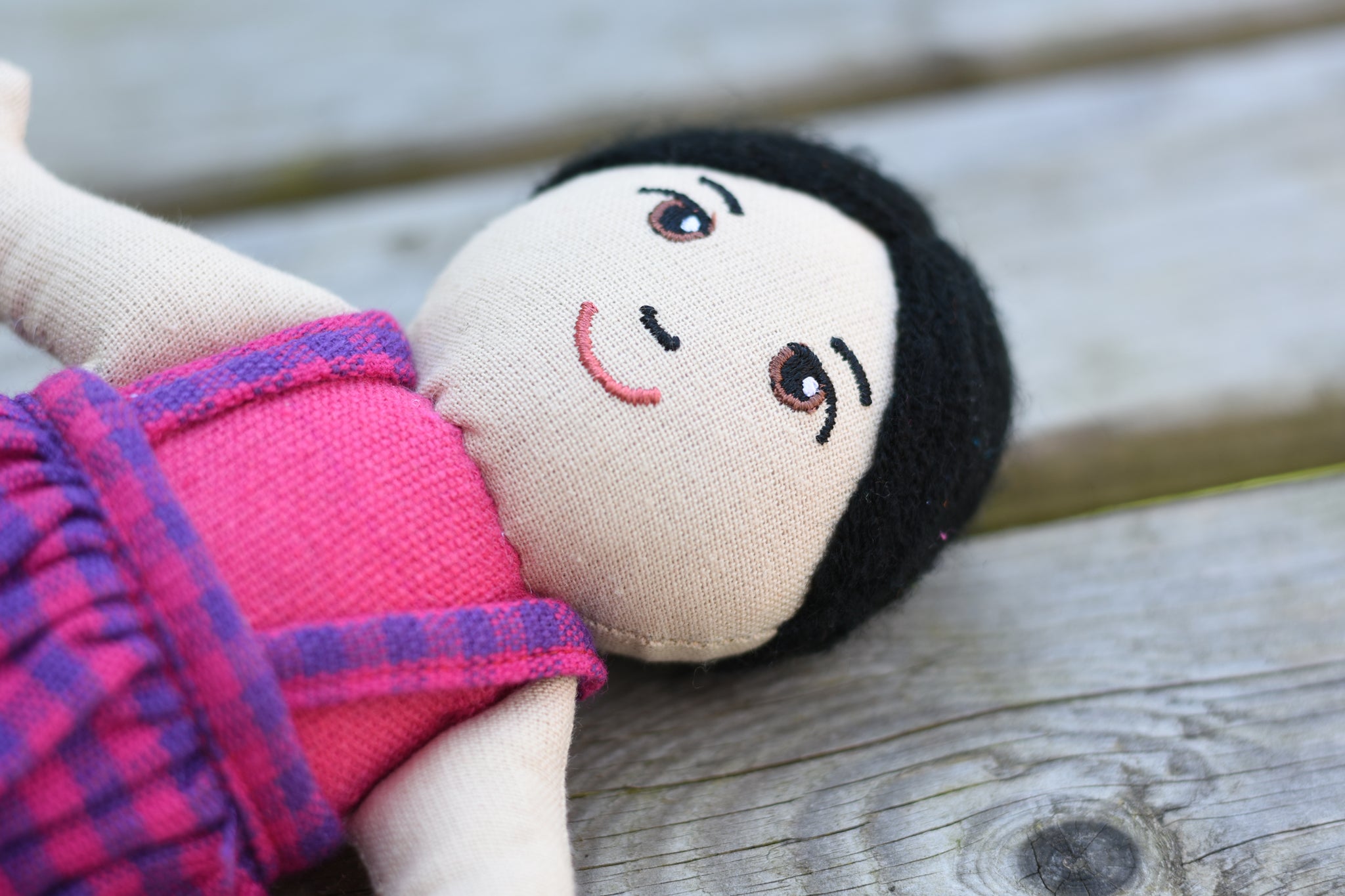 A close up of the face on the Lanka Kade Asian Girl Doll with White Skin and Black Hair.