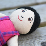 A close up of the face on the Lanka Kade Asian Girl Doll with White Skin and Black Hair.
