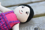 A close up of the face on the Lanka Kade Asian Girl Doll with White Skin and Black Hair.