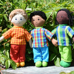 Three Lanka Kade dad dolls placed on a slate surface outdoors.  One doll has white skin and blonde hair, one has brown skin and black hair and the third has black skin and black hair. Their outfits are all made from sari offcut material so will come in random colours. 
