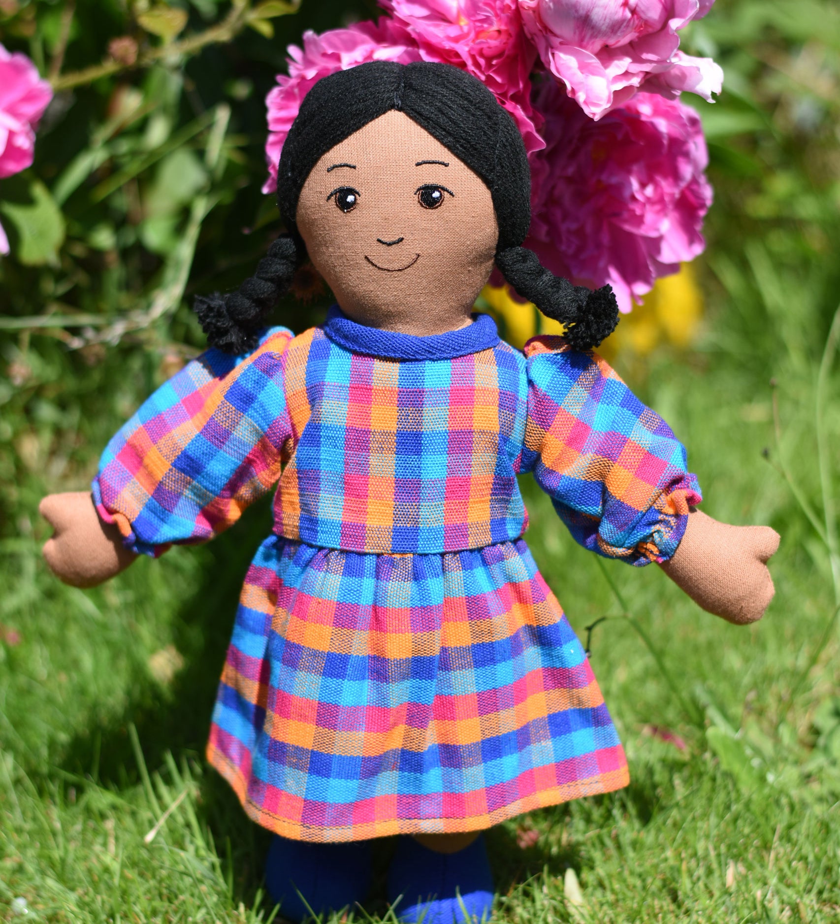A Lanka Kade Rag Doll Mum with Brown Skin and Black Hair. The doll is wearing a dress that has been made using off cuts from sari materials.