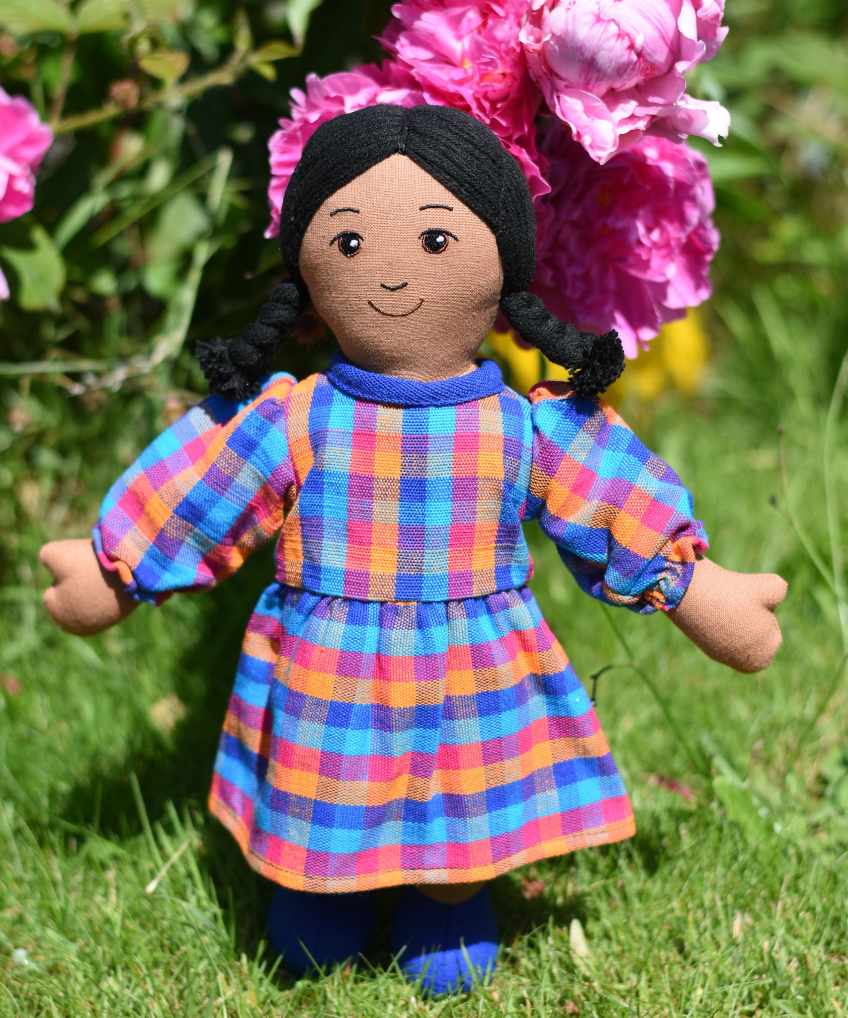 A Lanka Kade Rag Doll Mum with Brown Skin and Black Hair. The doll is wearing a dress that has been made using off cuts from sari materials.